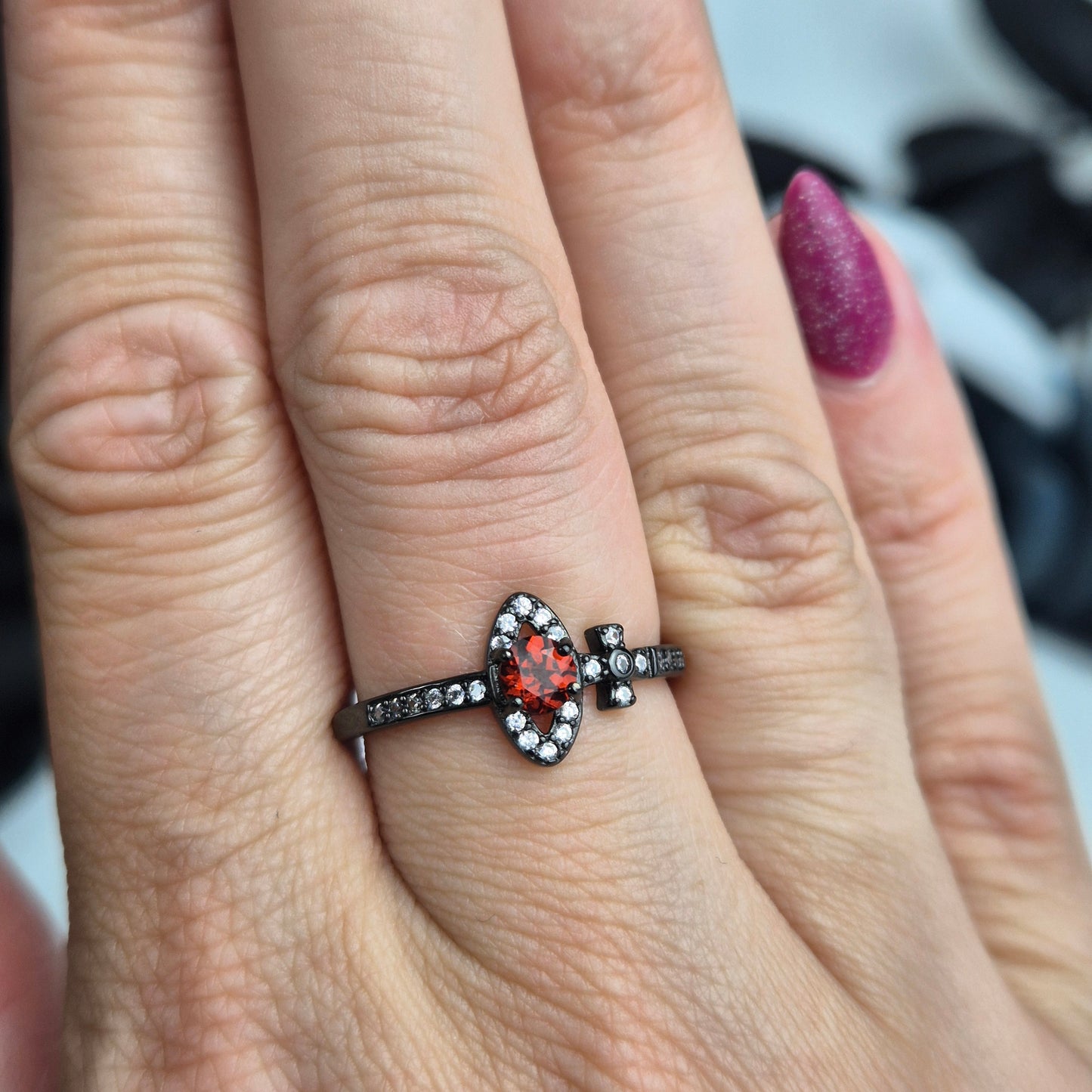 Garnet ring black cross