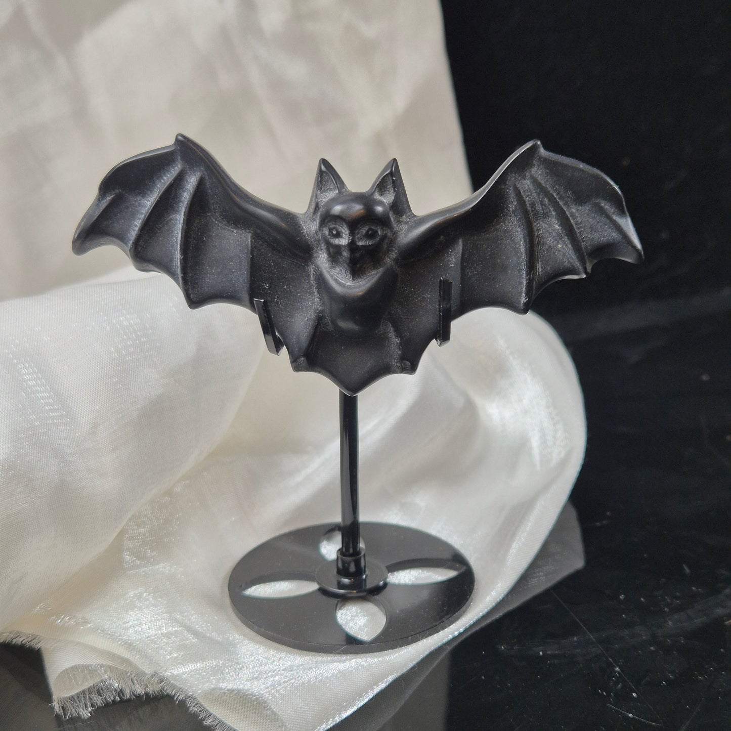 Black obsidian bat on stand